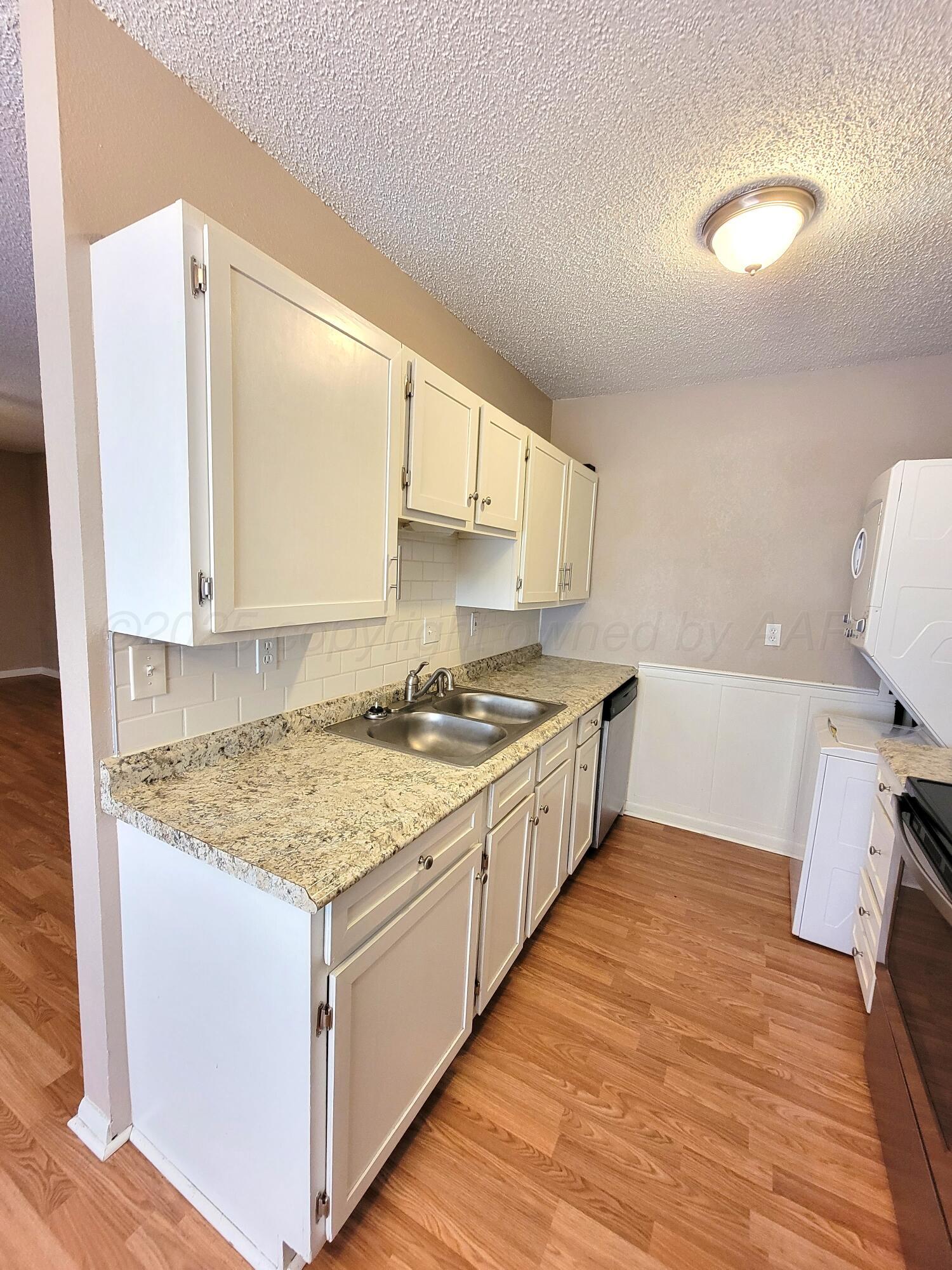 1312 Coffee Street Pampa, TX 79065 - Photo 25 of 31 a kitchen with a sink stove and cabinets