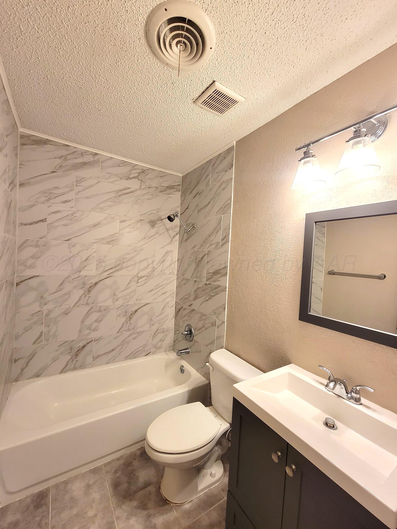 1312 Coffee Street Pampa, TX 79065 - Photo 30 of 31 a bathroom with a sink a toilet and a bathtub