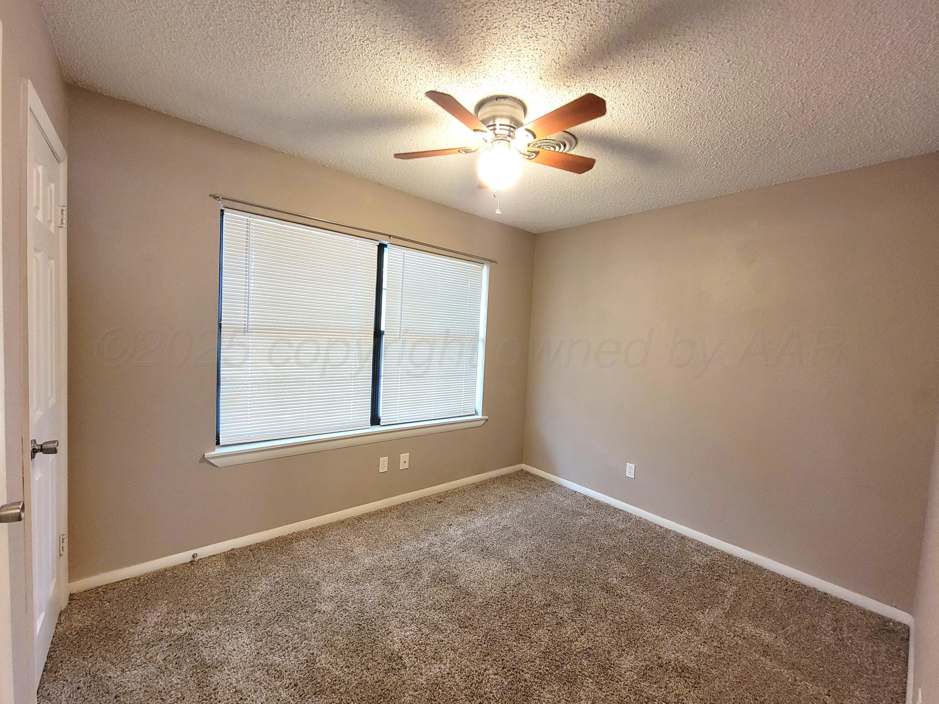 1312 Coffee Street Pampa, TX 79065 - Photo 31 of 31 an empty room with windows and fan