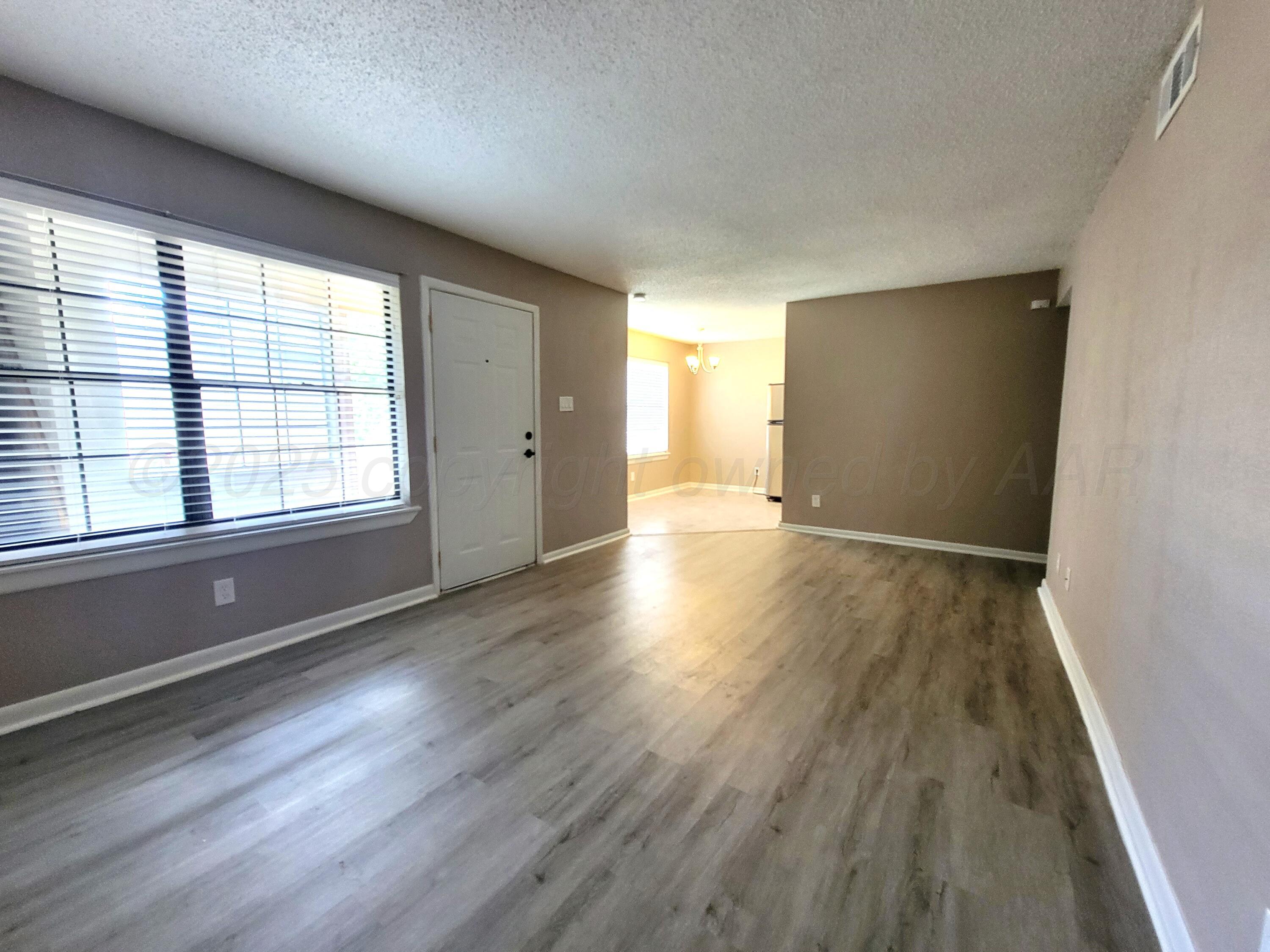 1312 Coffee Street Pampa, TX 79065 - Photo 4 of 31 wooden floor in an empty room with a window