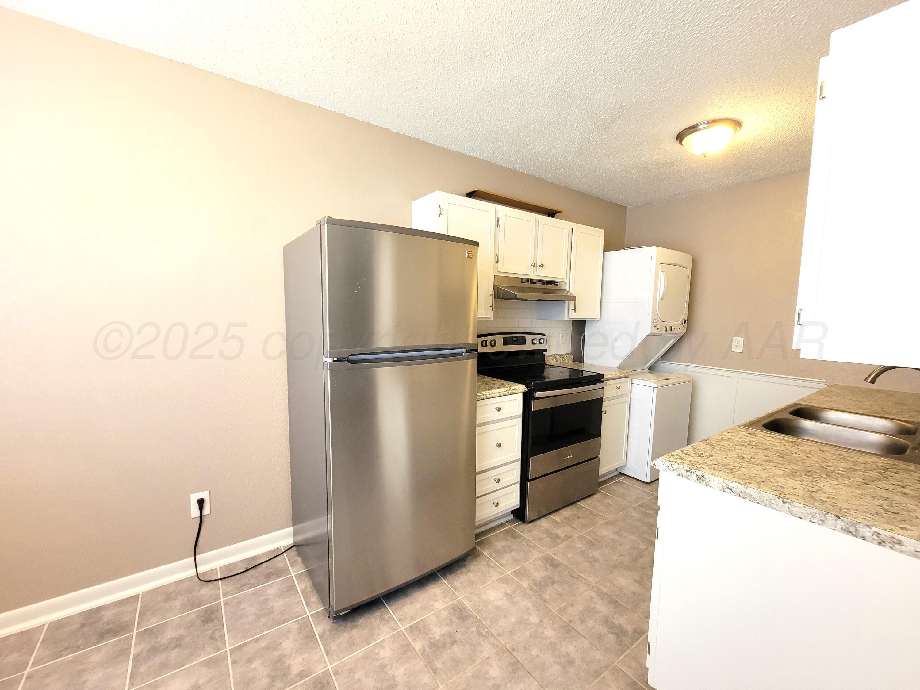 1312 Coffee Street Pampa, TX 79065 - Photo 5 of 31 a kitchen with a refrigerator and a stove