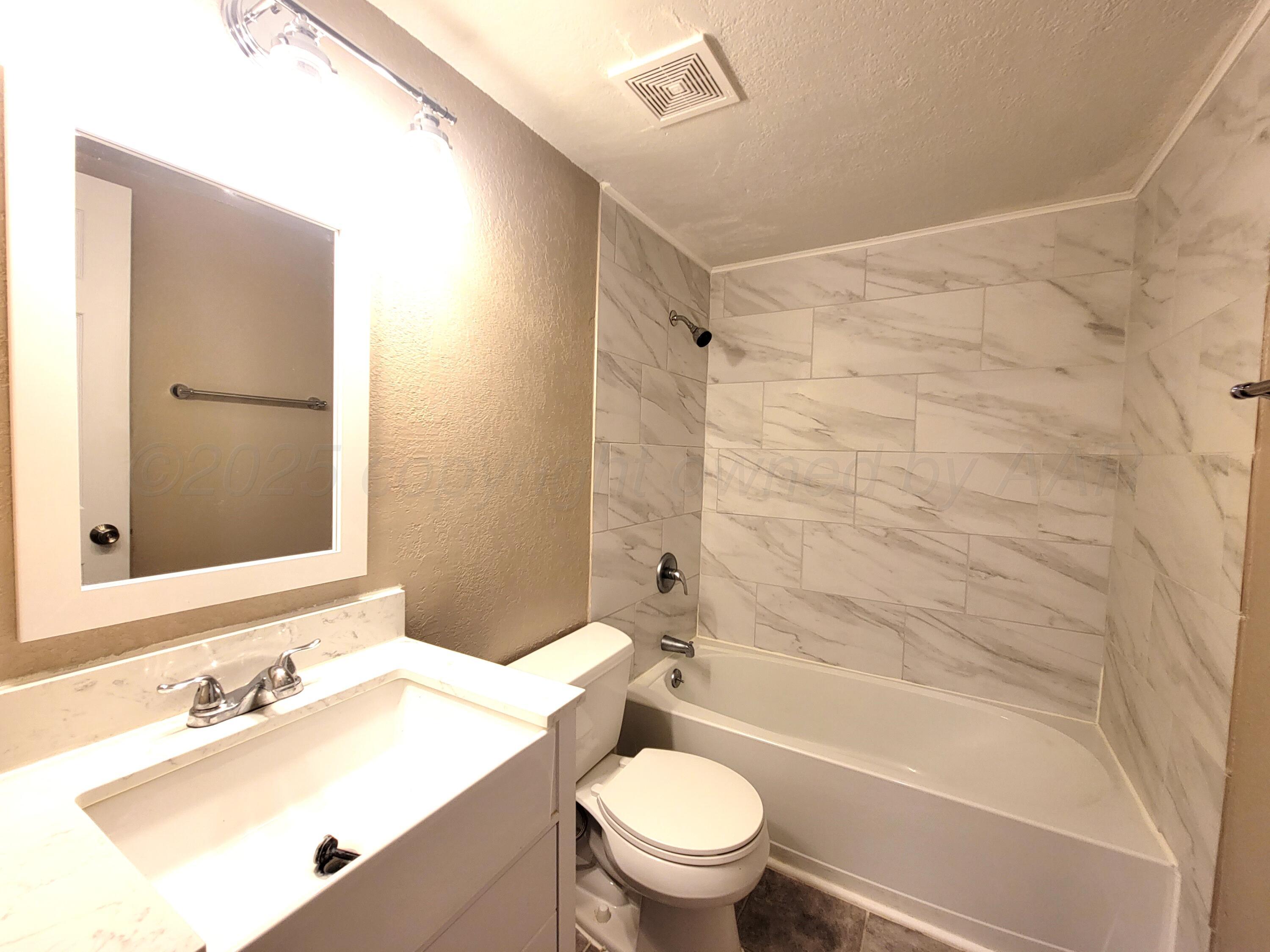 1312 Coffee Street Pampa, TX 79065 - Photo 9 of 31 a bathroom with a sink toilet and shower