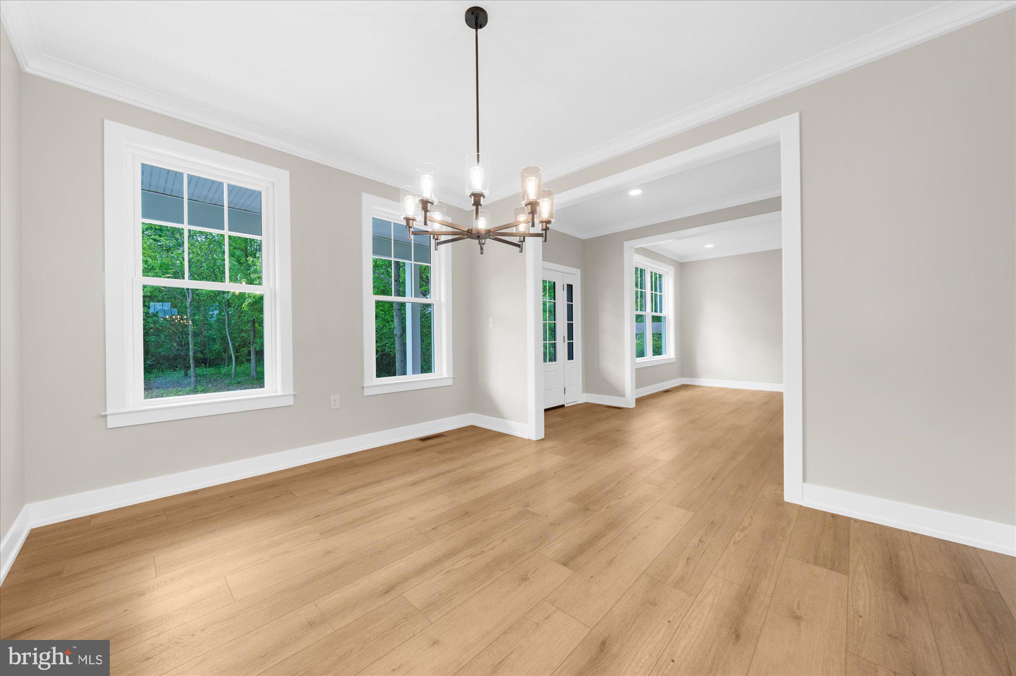 394 Renninger Road Perkiomenville, PA 18074 - Photo 12 of 41 a view of a room with wooden floor chandeliers and kitchen view