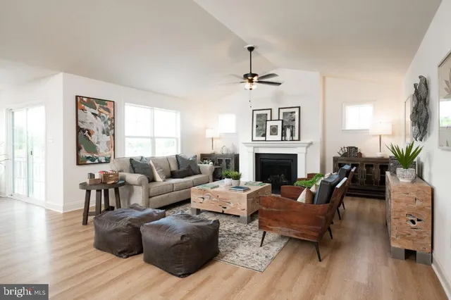 a bedroom with a bed and a dresser next to a window