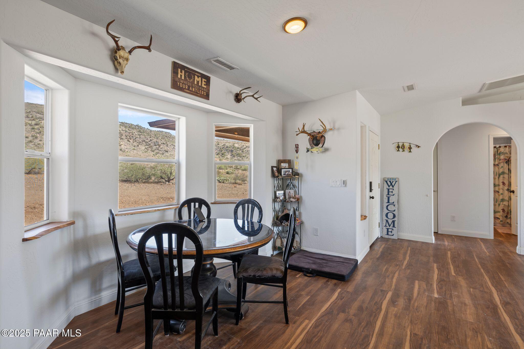 17200 South Dripping Springs Road Mayer, AZ 86333 - Photo 12 of 51 a view of a dining room with furniture and wooden floor