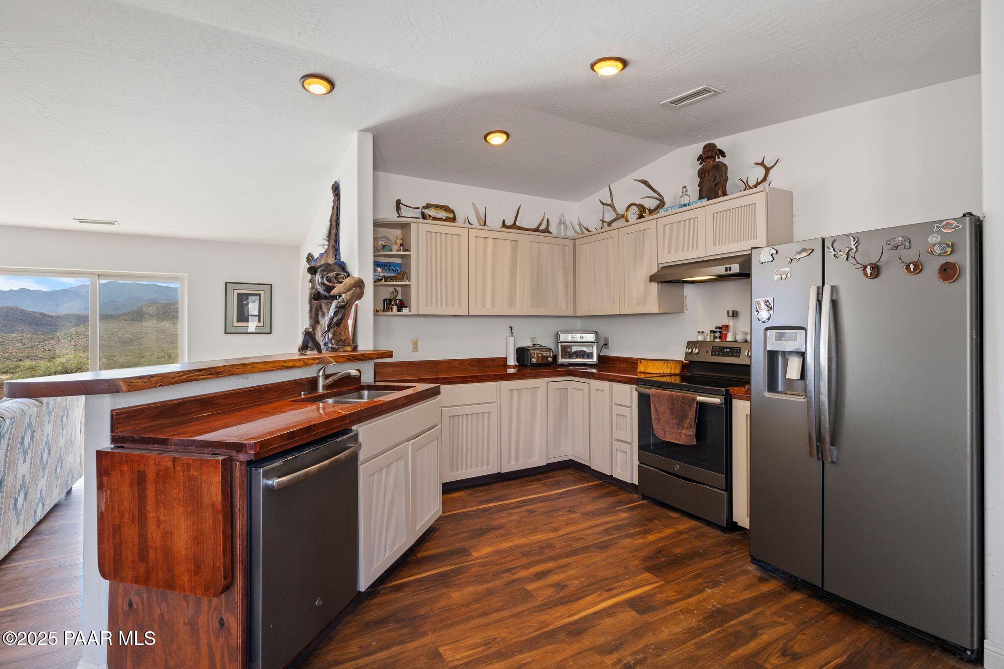 17200 South Dripping Springs Road Mayer, AZ 86333 - Photo 13 of 51 a kitchen with stainless steel appliances granite countertop a stove and a refrigerator