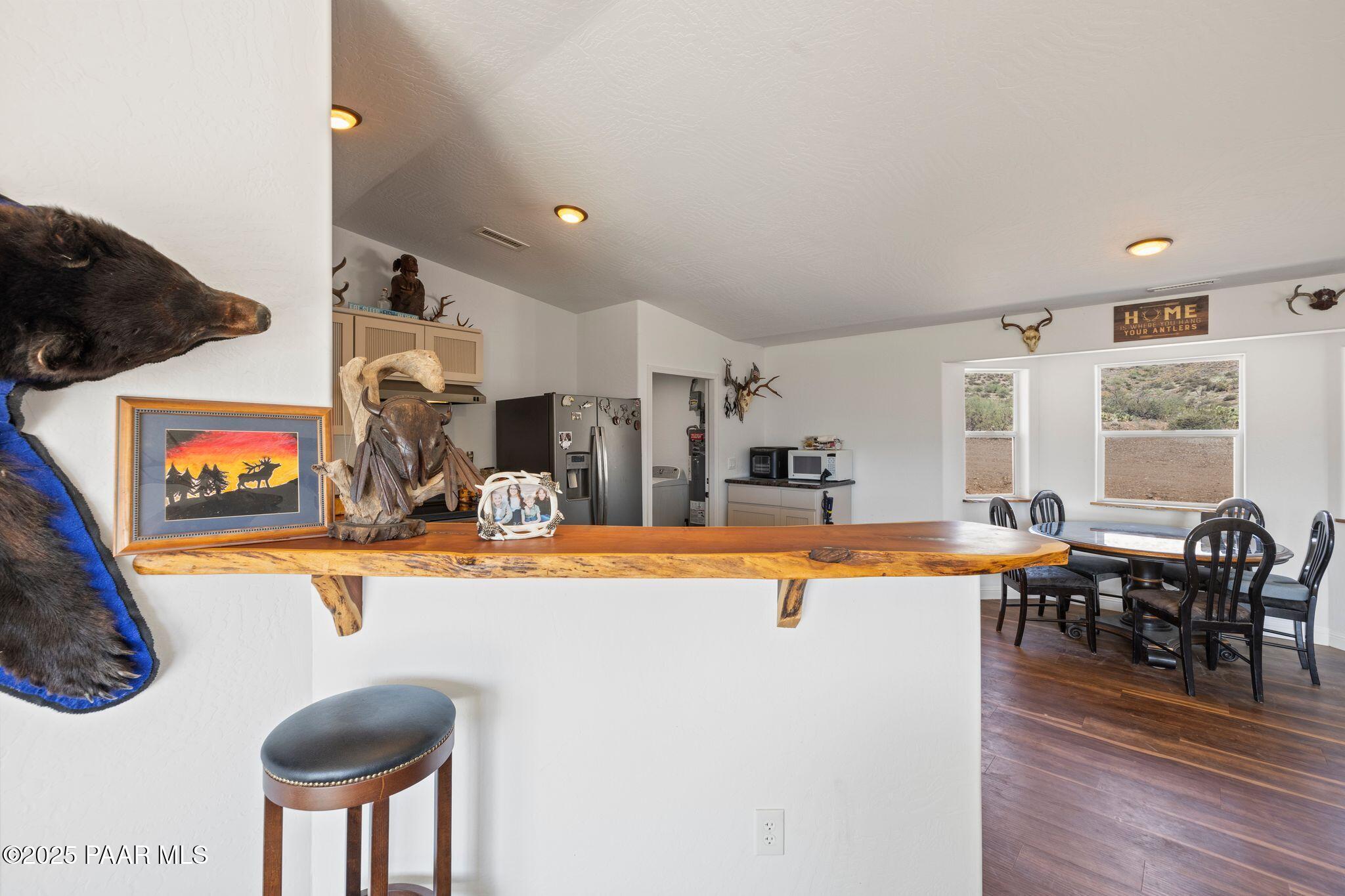 17200 South Dripping Springs Road Mayer, AZ 86333 - Photo 15 of 51 a view of a dining room with furniture a chandelier and wooden floor