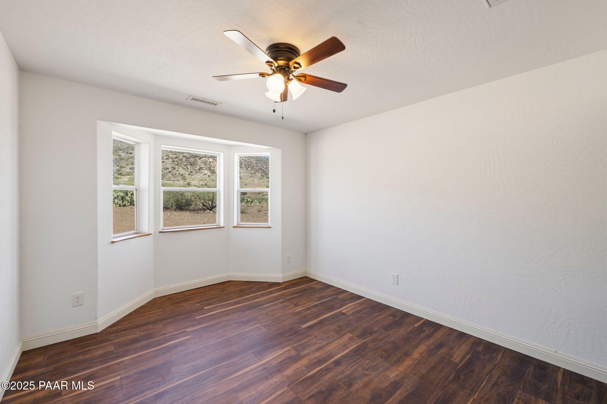17200 South Dripping Springs Road Mayer, AZ 86333 - Photo 20 of 51 wooden floor in an empty room with a window