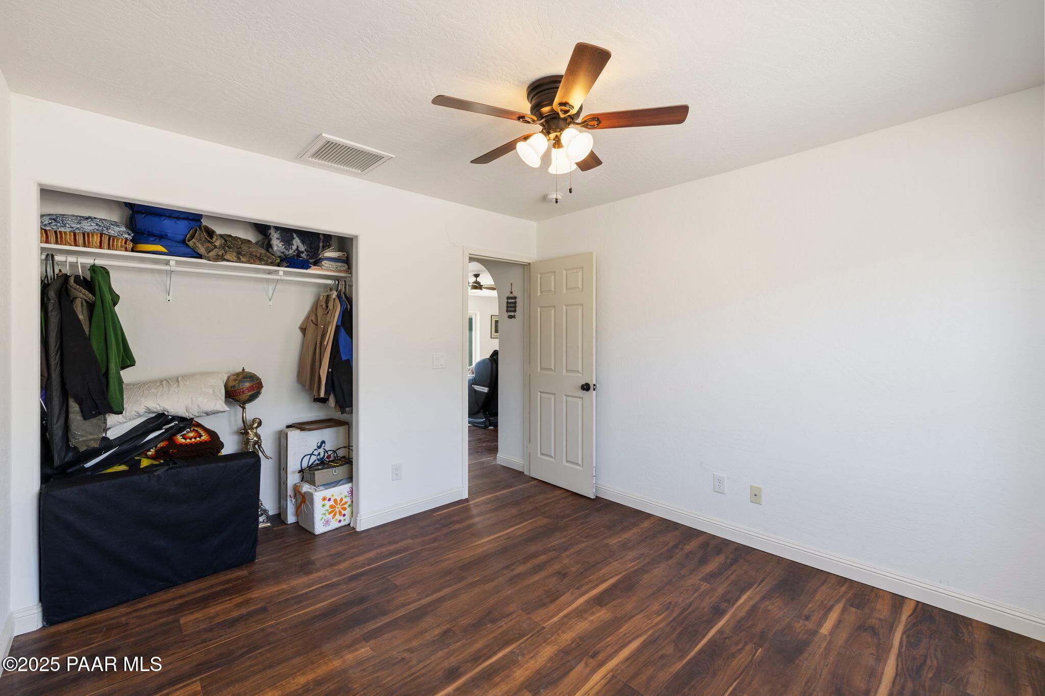17200 South Dripping Springs Road Mayer, AZ 86333 - Photo 21 of 51 a view of a livingroom with wooden floor and a ceiling fan