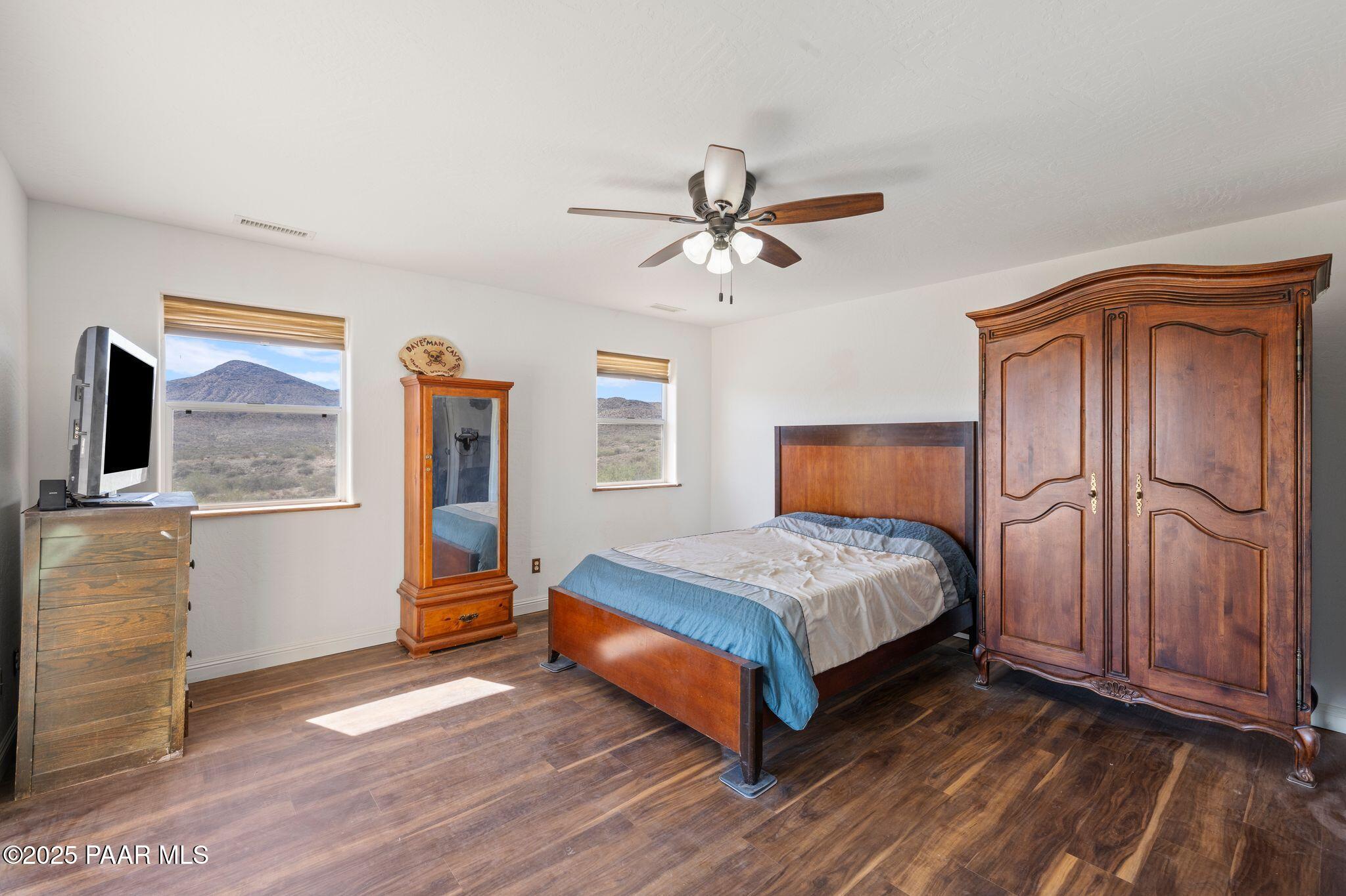 17200 South Dripping Springs Road Mayer, AZ 86333 - Photo 26 of 51 a bedroom with a bed and wooden floor