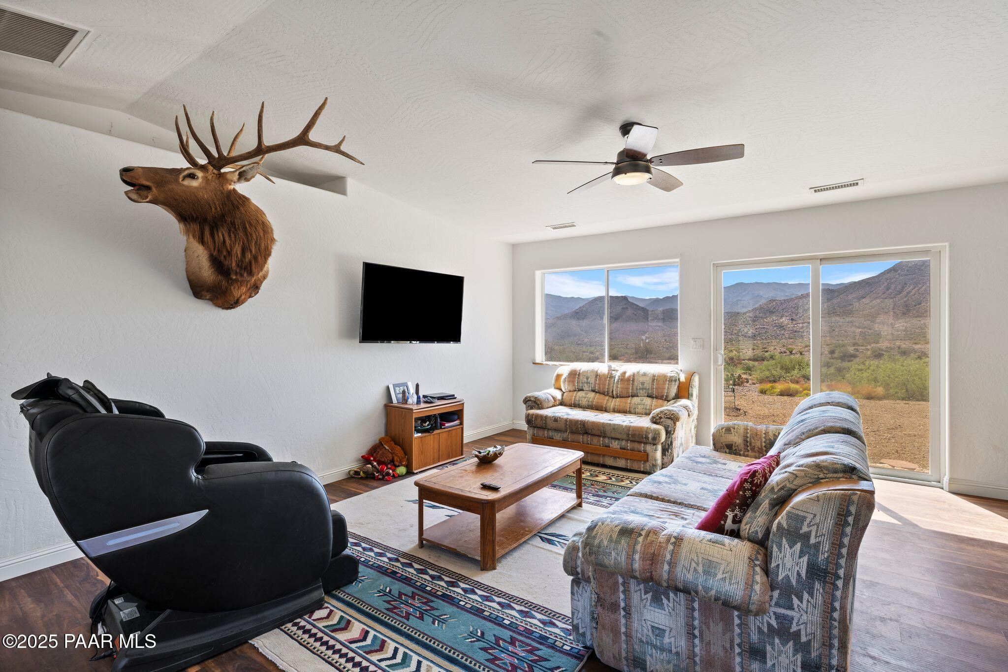 17200 South Dripping Springs Road Mayer, AZ 86333 - Photo 7 of 51 a living room with furniture a flat screen tv and a large window