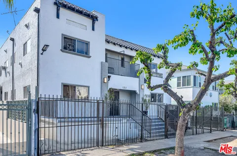 a view of a brick house with many windows