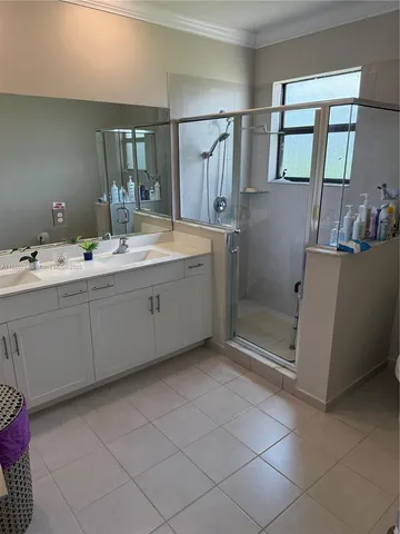 a bathroom with a double vanity sink and mirror