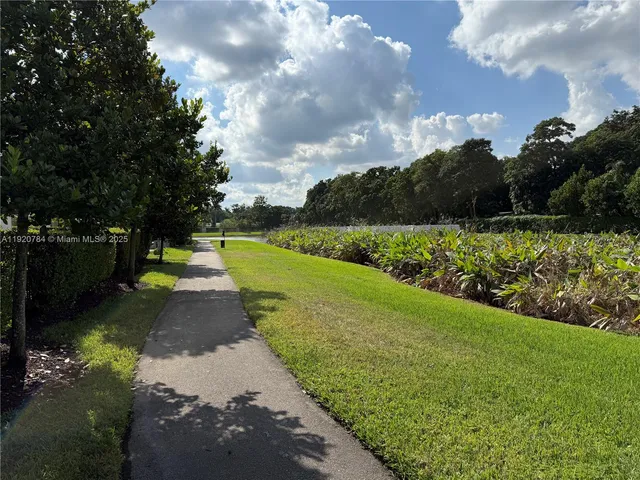 a view of a garden with houses in back