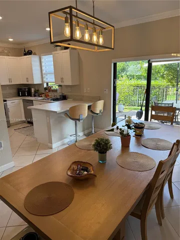 a kitchen with a table chairs stove and cabinets