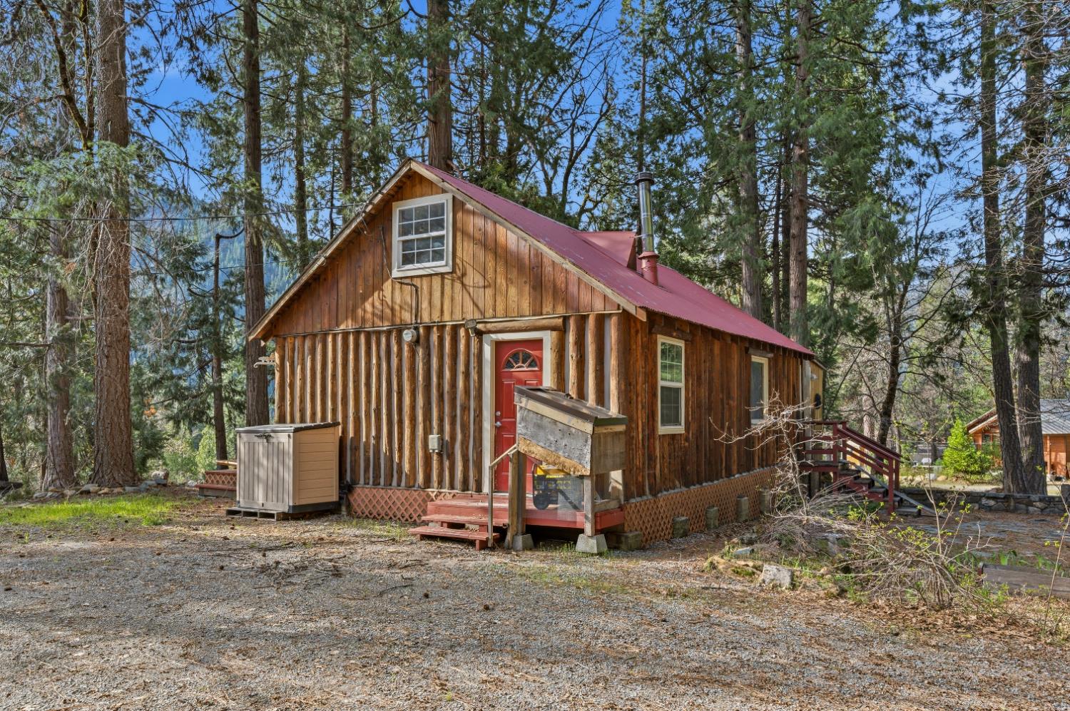 38 Valhalla Road Sierra City, CA 96125 - Photo 2 of 27 a view of a small house with a yard and a large tree