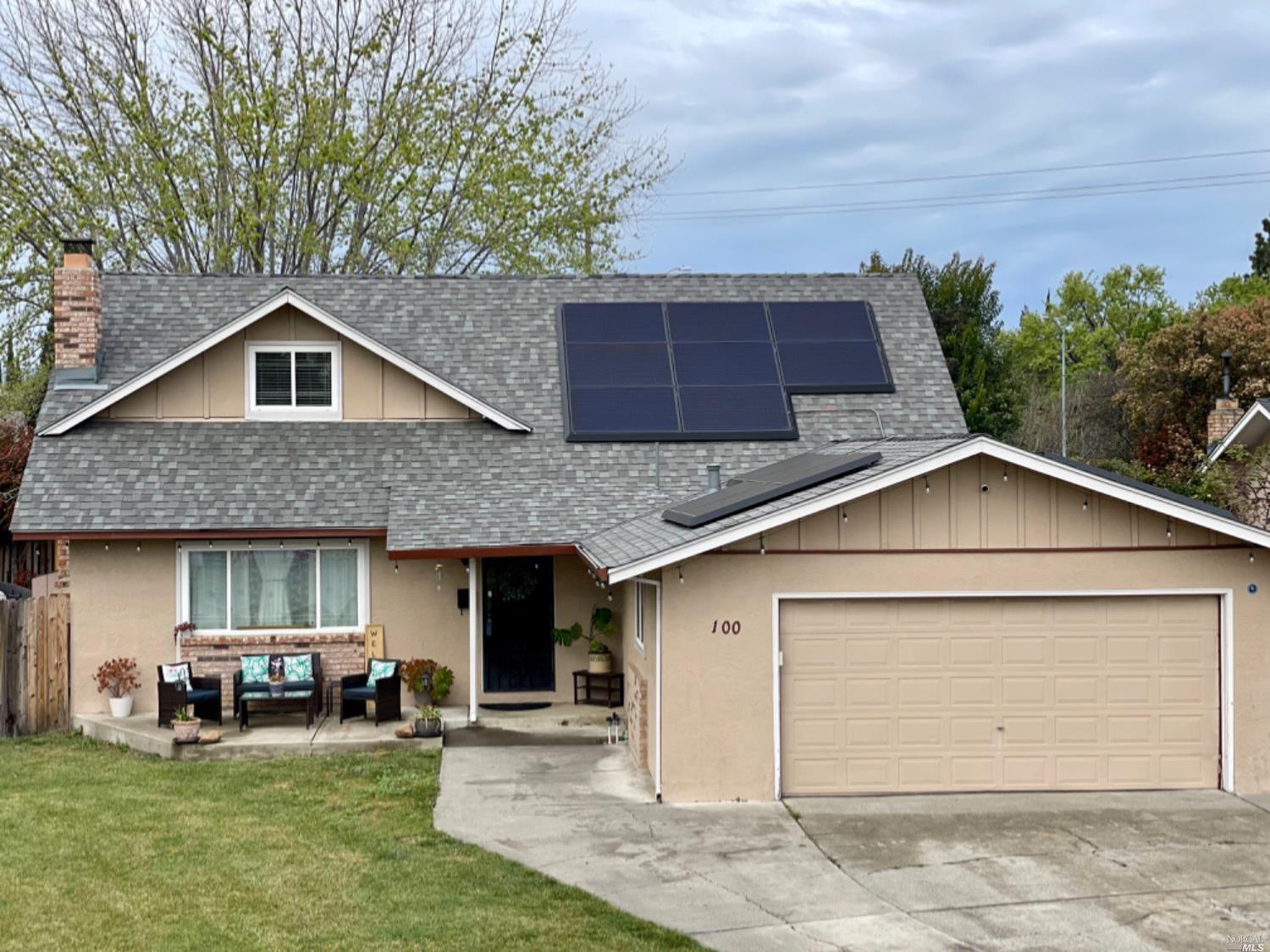 a front view of a house with a garden and plants