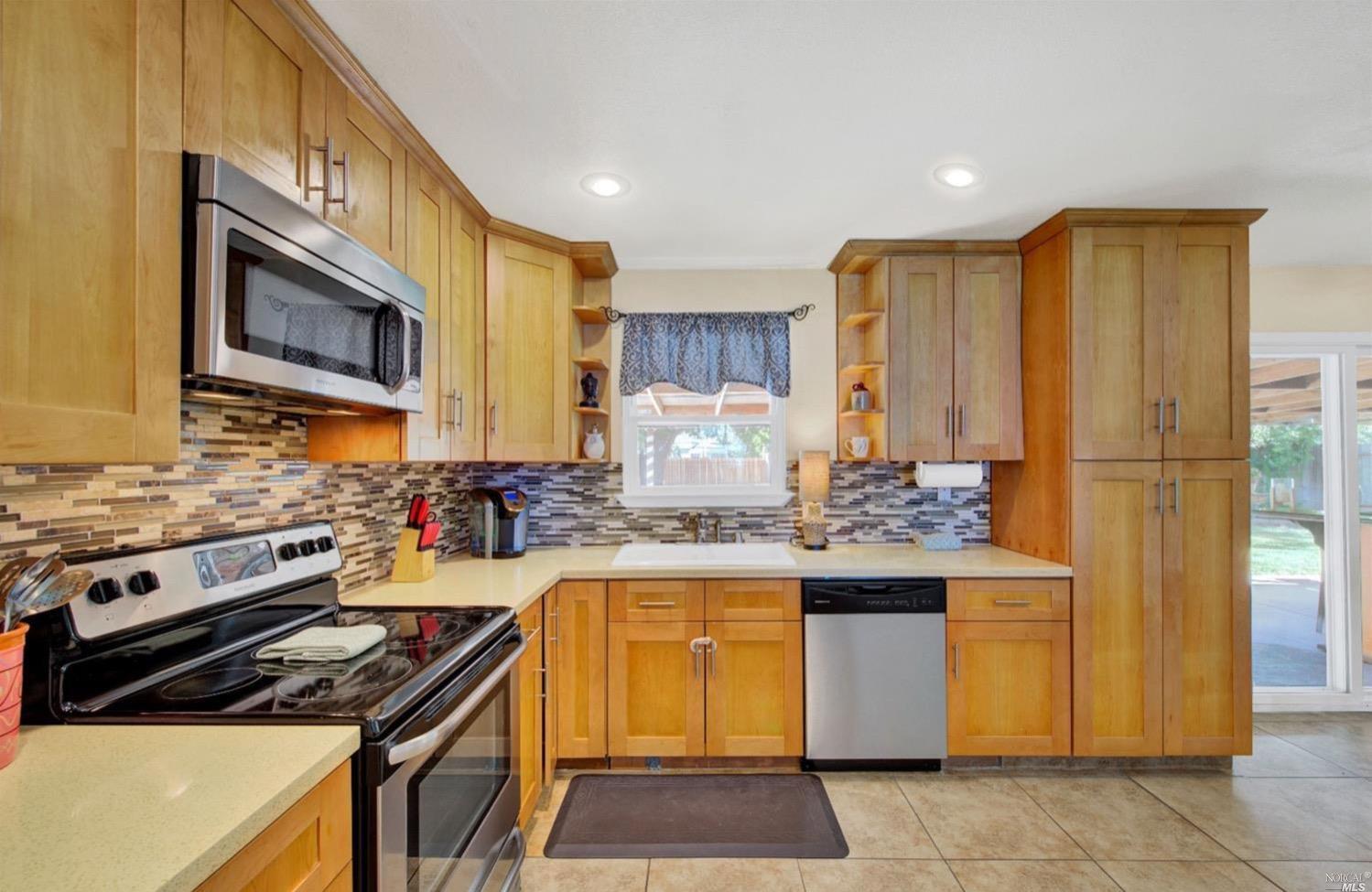 100 Arrowhead Court Vacaville, CA 95687 - Photo 11 of 40 a kitchen with stainless steel appliances granite countertop a stove and a refrigerator