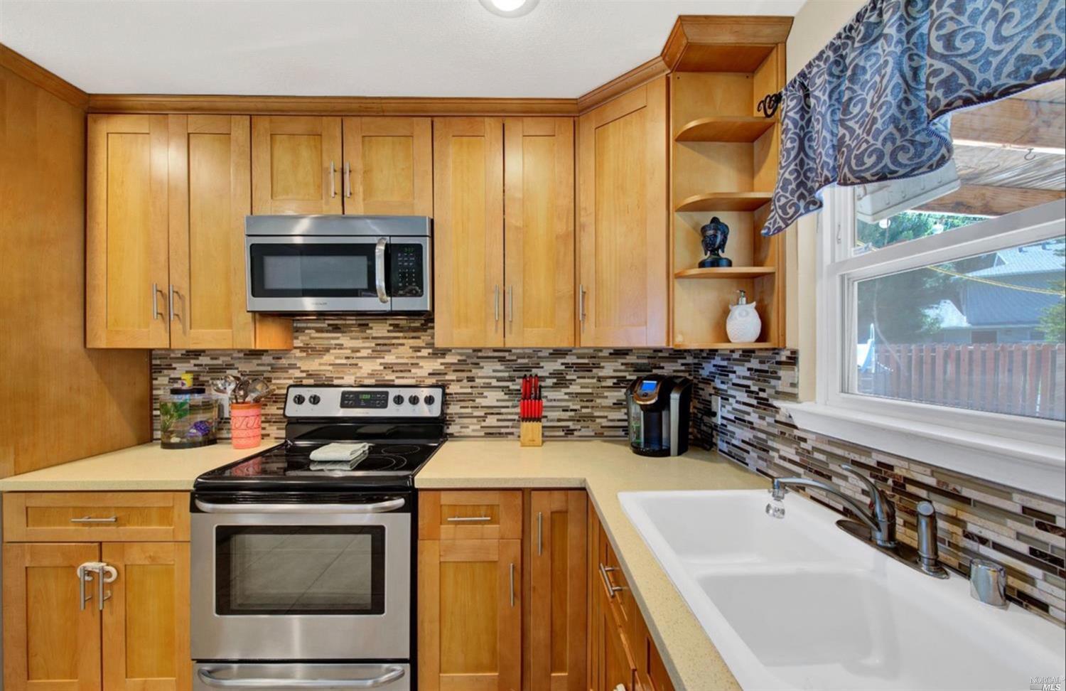 100 Arrowhead Court Vacaville, CA 95687 - Photo 13 of 40 a kitchen with stainless steel appliances a stove a sink and a microwave