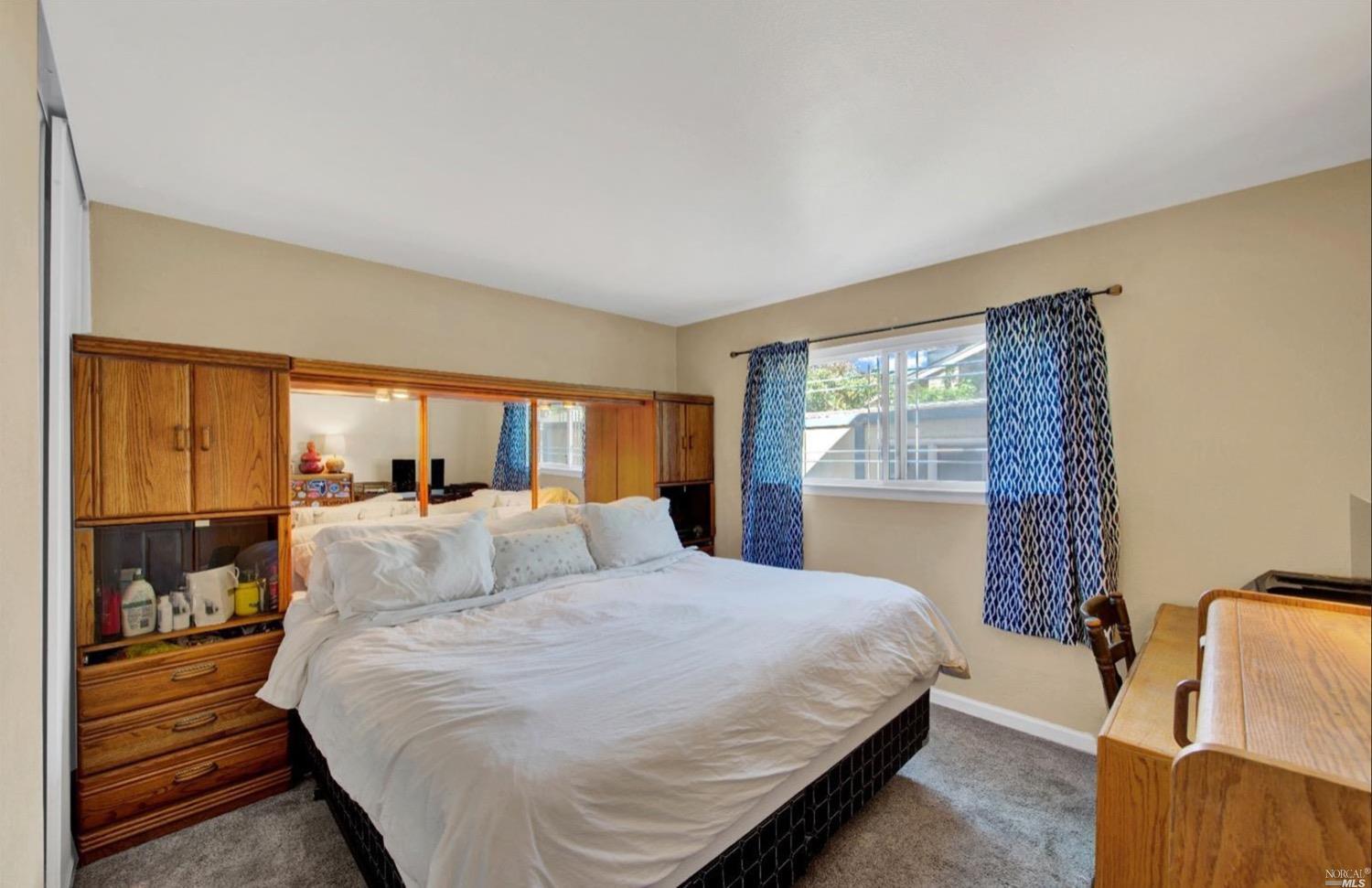 100 Arrowhead Court Vacaville, CA 95687 - Photo 17 of 40 a bedroom with a large bed and a window