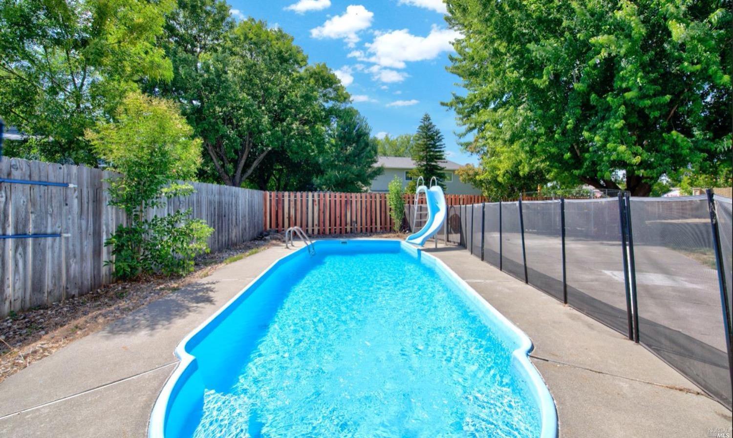 100 Arrowhead Court Vacaville, CA 95687 - Photo 35 of 40 a view of a backyard with large tree and wooden fence
