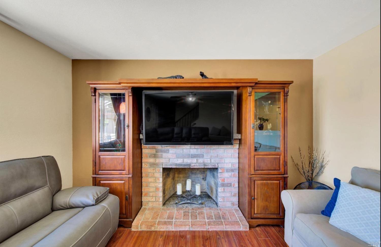 100 Arrowhead Court Vacaville, CA 95687 - Photo 6 of 40 a living room with furniture and a fireplace