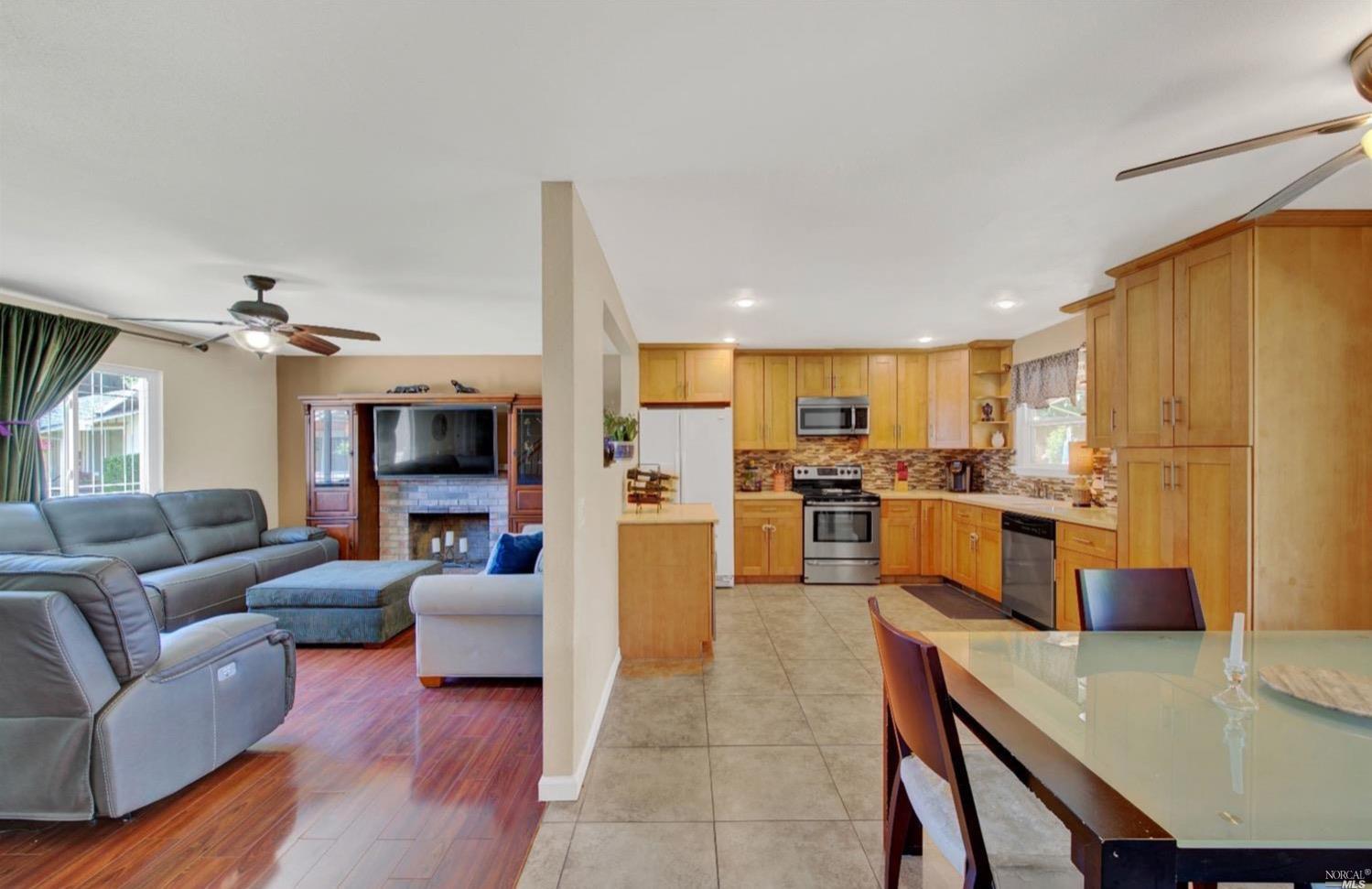 100 Arrowhead Court Vacaville, CA 95687 - Photo 9 of 40 a living room with stainless steel appliances kitchen island granite countertop furniture and a view of kitchen