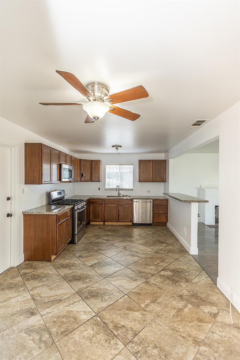2105 Norman Way Modesto, CA 95350 - Photo 11 of 34 a view of a kitchen with a sink and cabinets