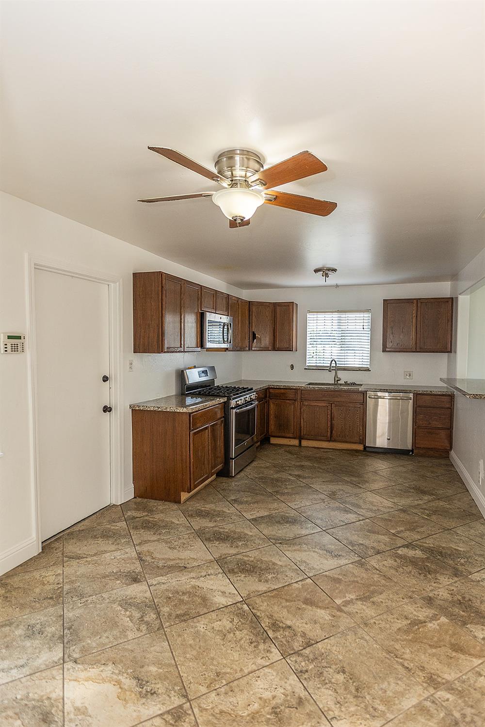 2105 Norman Way Modesto, CA 95350 - Photo 12 of 34 a large kitchen with stainless steel appliances granite countertop a sink counter space and cabinets