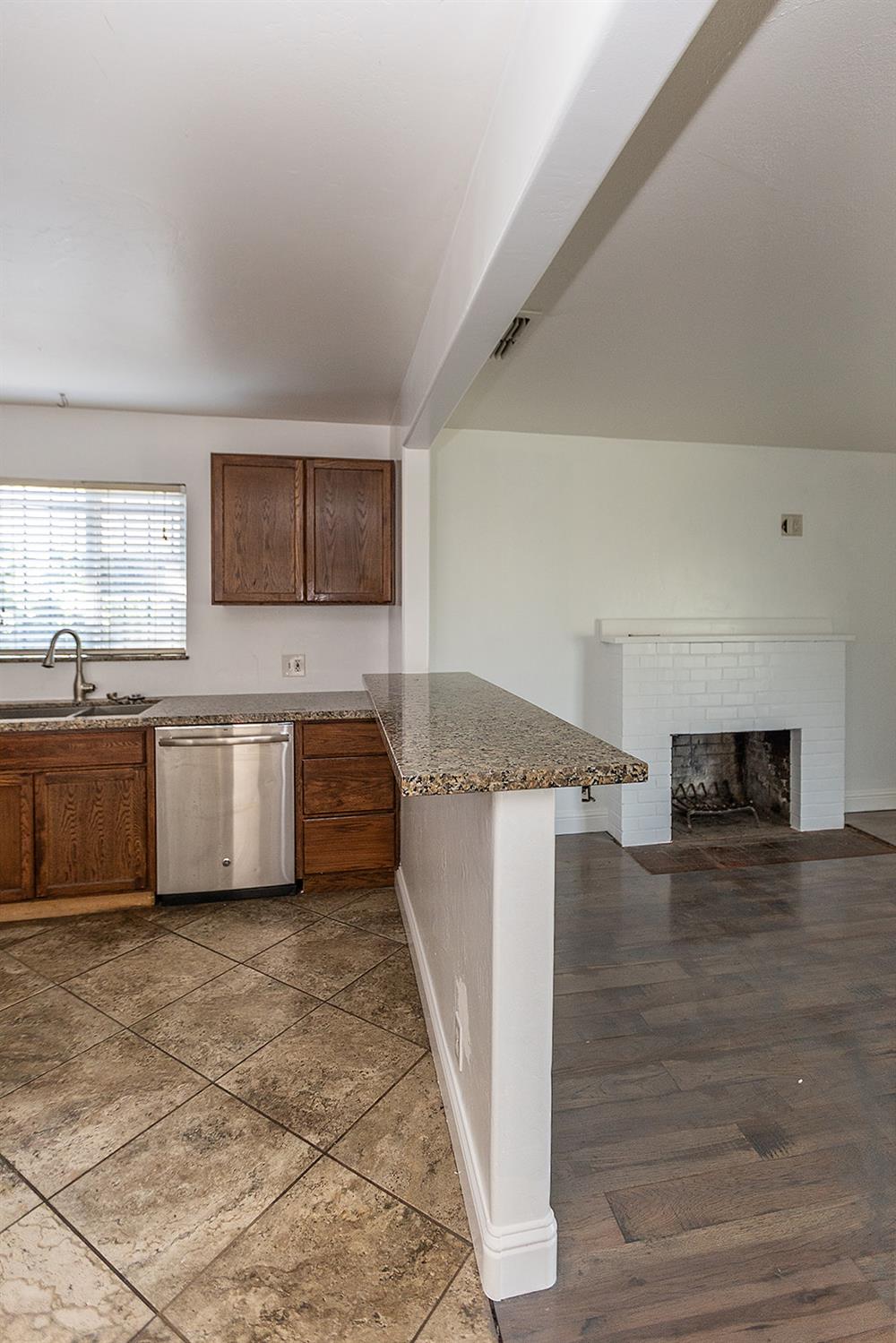 2105 Norman Way Modesto, CA 95350 - Photo 15 of 34 a kitchen with stainless steel appliances granite countertop a sink and a stove top oven