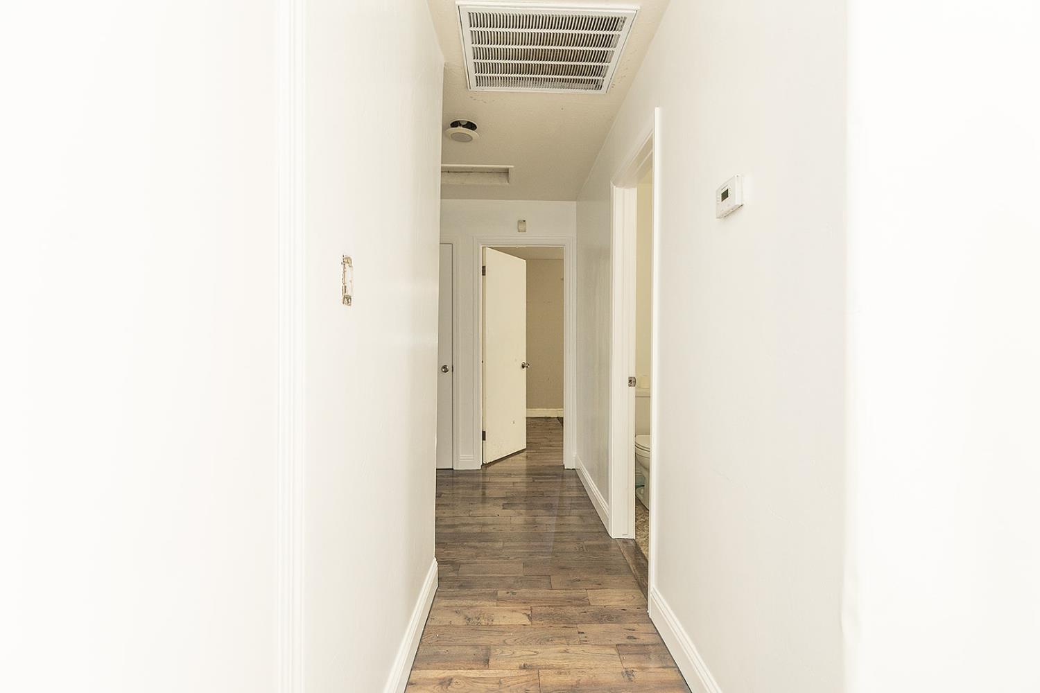 2105 Norman Way Modesto, CA 95350 - Photo 20 of 34 a view of a hallway with wooden floor