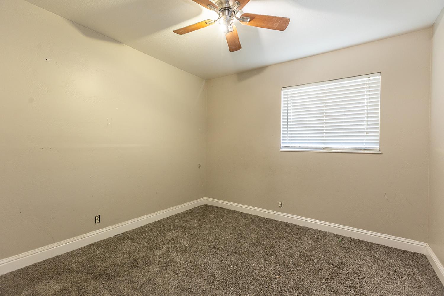2105 Norman Way Modesto, CA 95350 - Photo 24 of 34 an empty room with a window and a fan