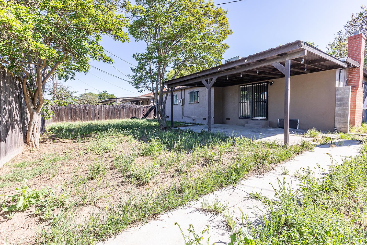 2105 Norman Way Modesto, CA 95350 - Photo 30 of 34 a front view of a house with a yard and pathway