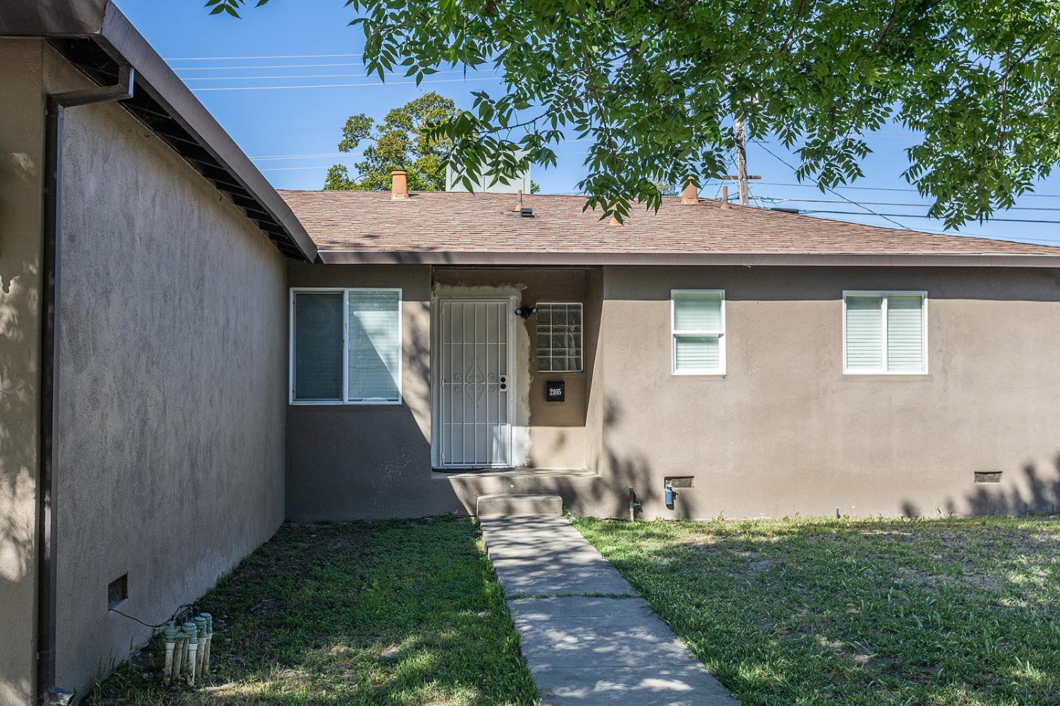 2105 Norman Way Modesto, CA 95350 - Photo 5 of 34 a front view of a house with garden