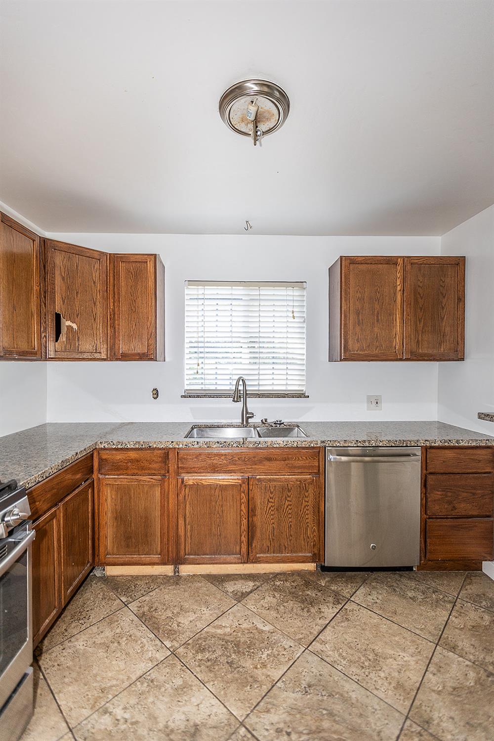 2105 Norman Way Modesto, CA 95350 - Photo 9 of 34 a large kitchen with granite countertop a sink and a stove