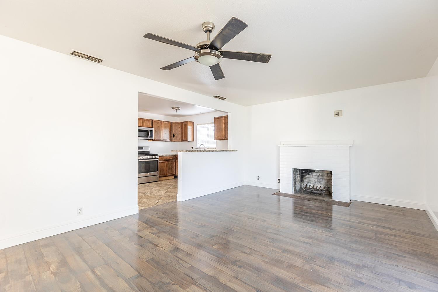2105 Norman Way Modesto, CA 95350 - Photo 10 of 34 a view of empty room with wooden floor and window