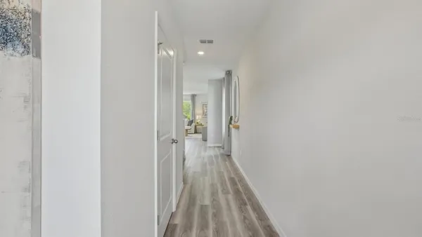 a view of a room with wooden floor