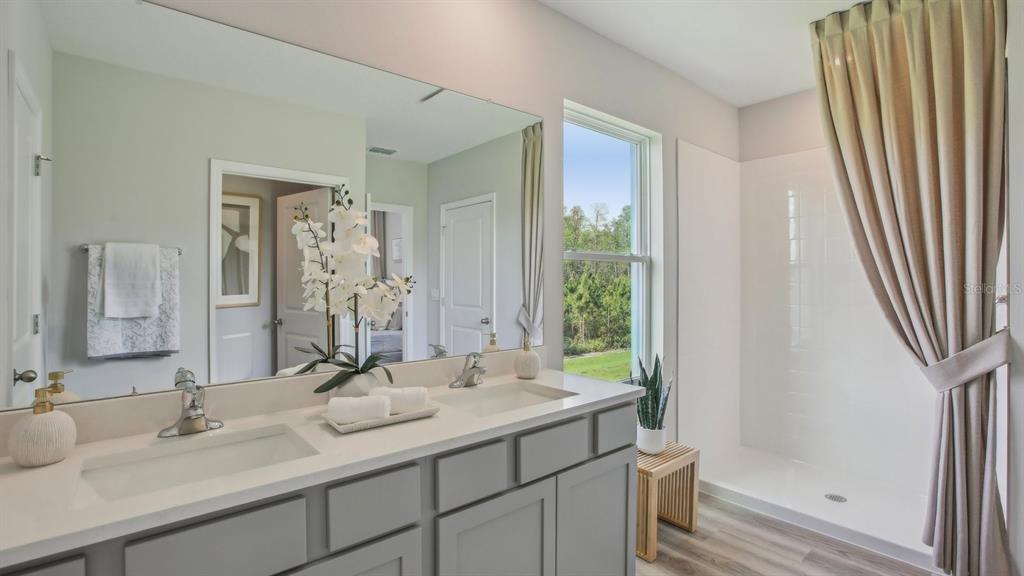 35293 Vly Rdg Road Dade City, FL 33525 - Photo 30 of 36 a bathroom with a double vanity sink and a mirror
