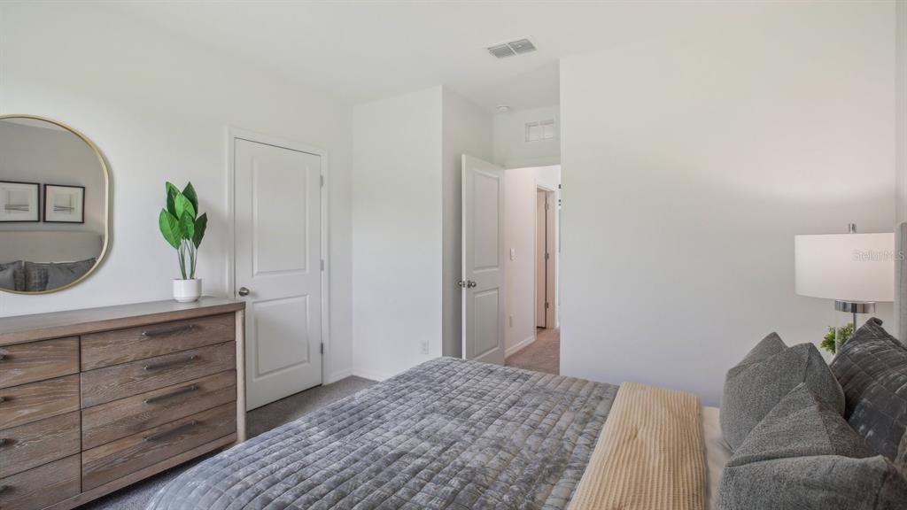 35293 Vly Rdg Road Dade City, FL 33525 - Photo 35 of 36 a bedroom with a bed and a dresser in it