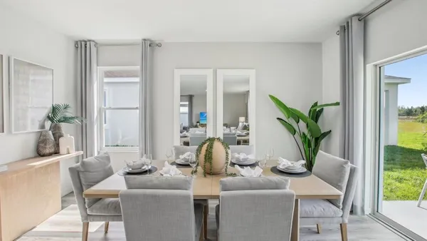 a dining room with furniture and wooden floor