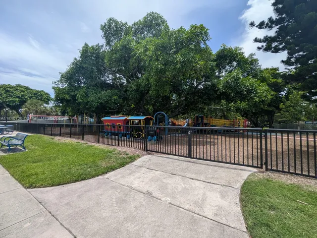 a view of a park with iron fence