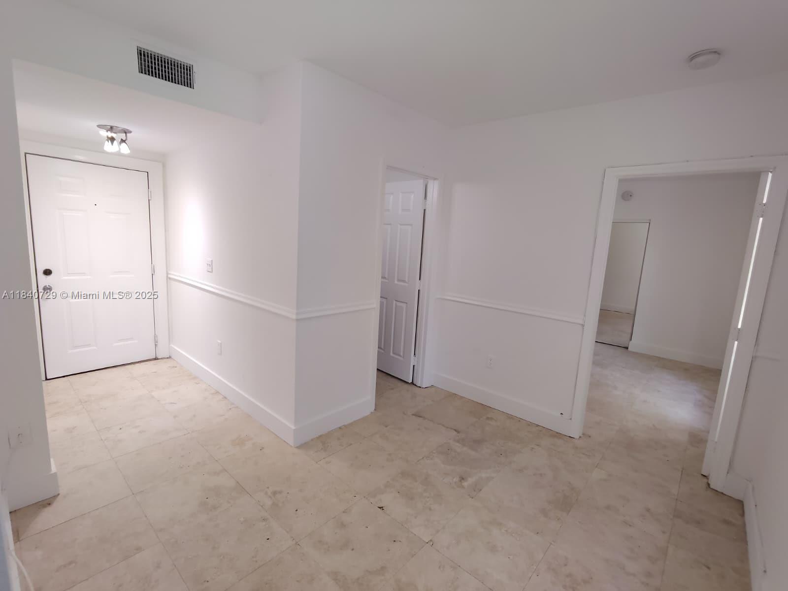 1008 Jefferson Avenue, Unit 202 Miami Beach, FL 33139 - Photo 4 of 16 an empty room with closet and windows