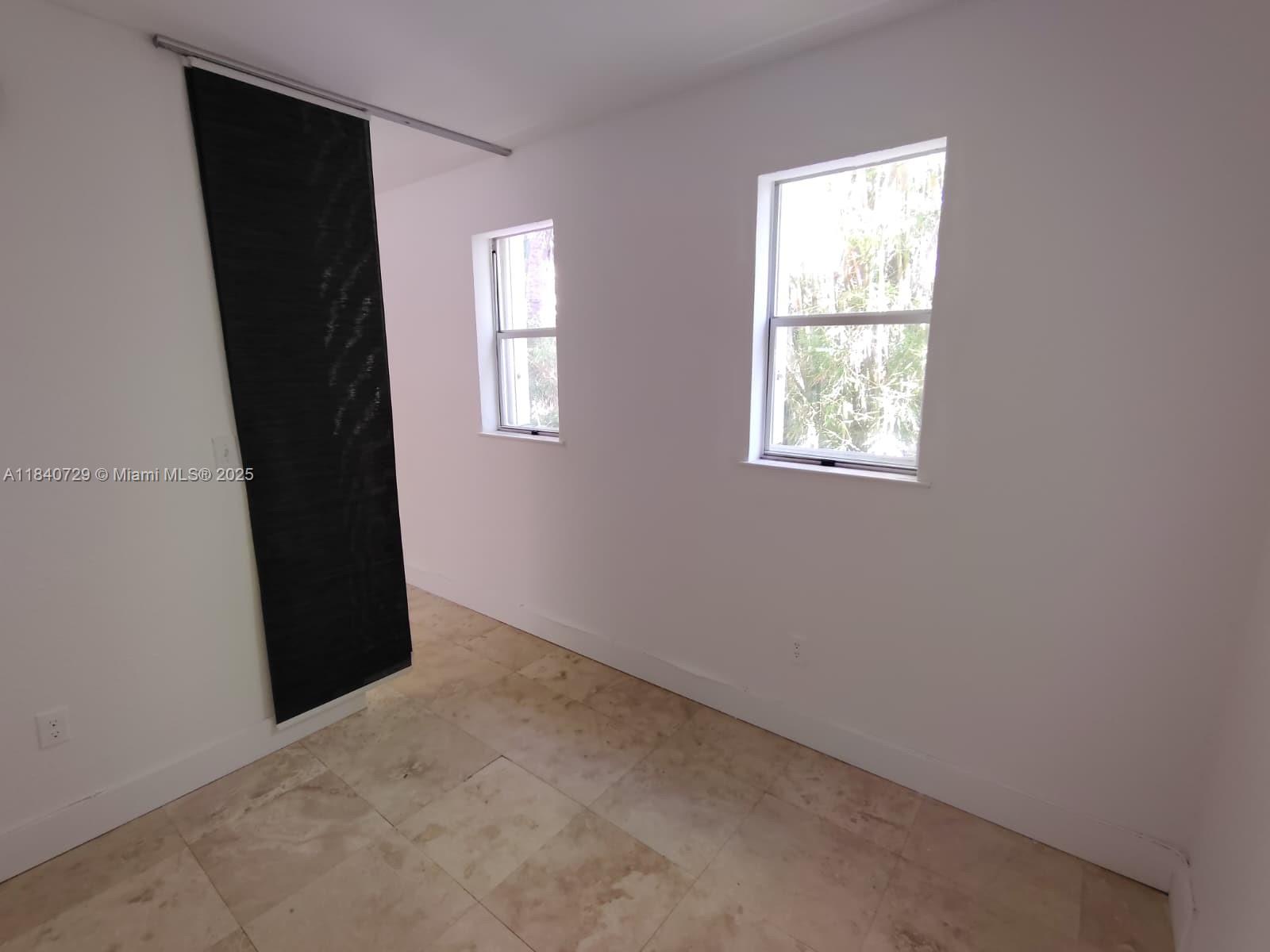 1008 Jefferson Avenue, Unit 202 Miami Beach, FL 33139 - Photo 6 of 16 an empty room with windows