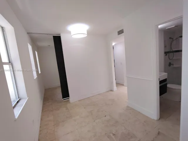 a view of a room with walk in closet and wooden floor