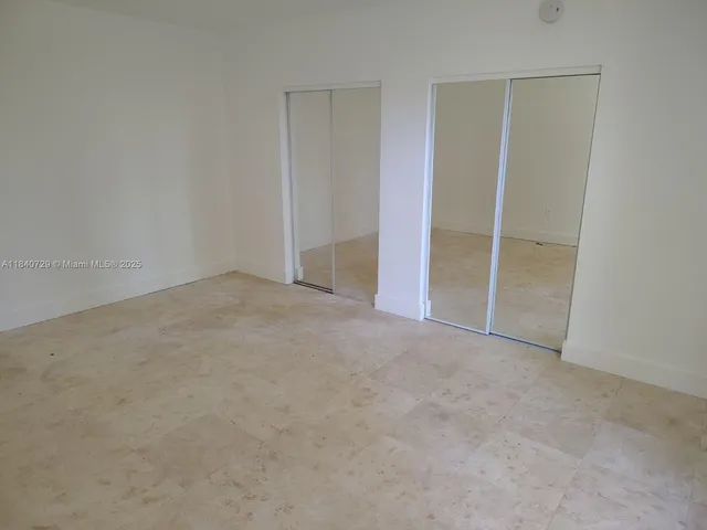 an empty room with closet area