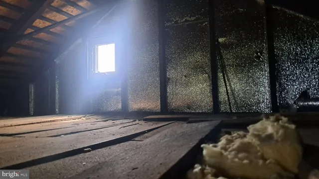 a view of a white house next to a yard