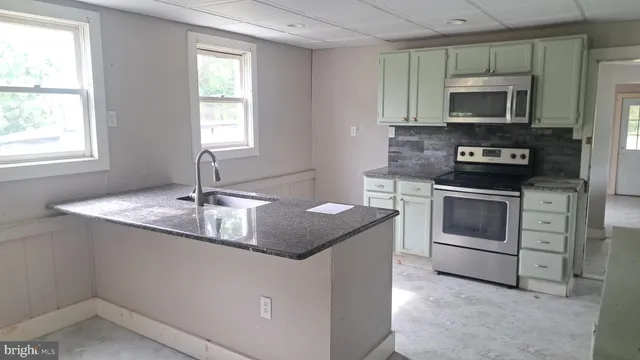 a kitchen with a stove and a microwave