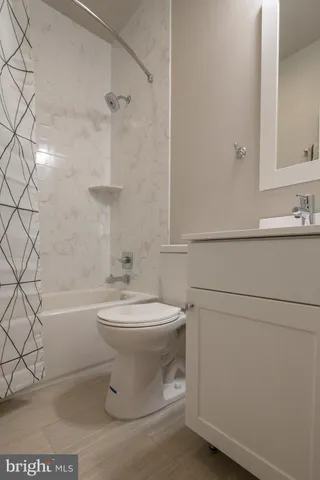 a bathroom with a toilet a sink and bathtub