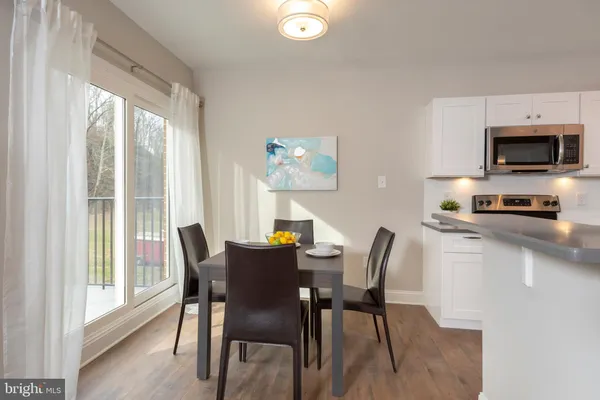 a view of a dining room with furniture and a window
