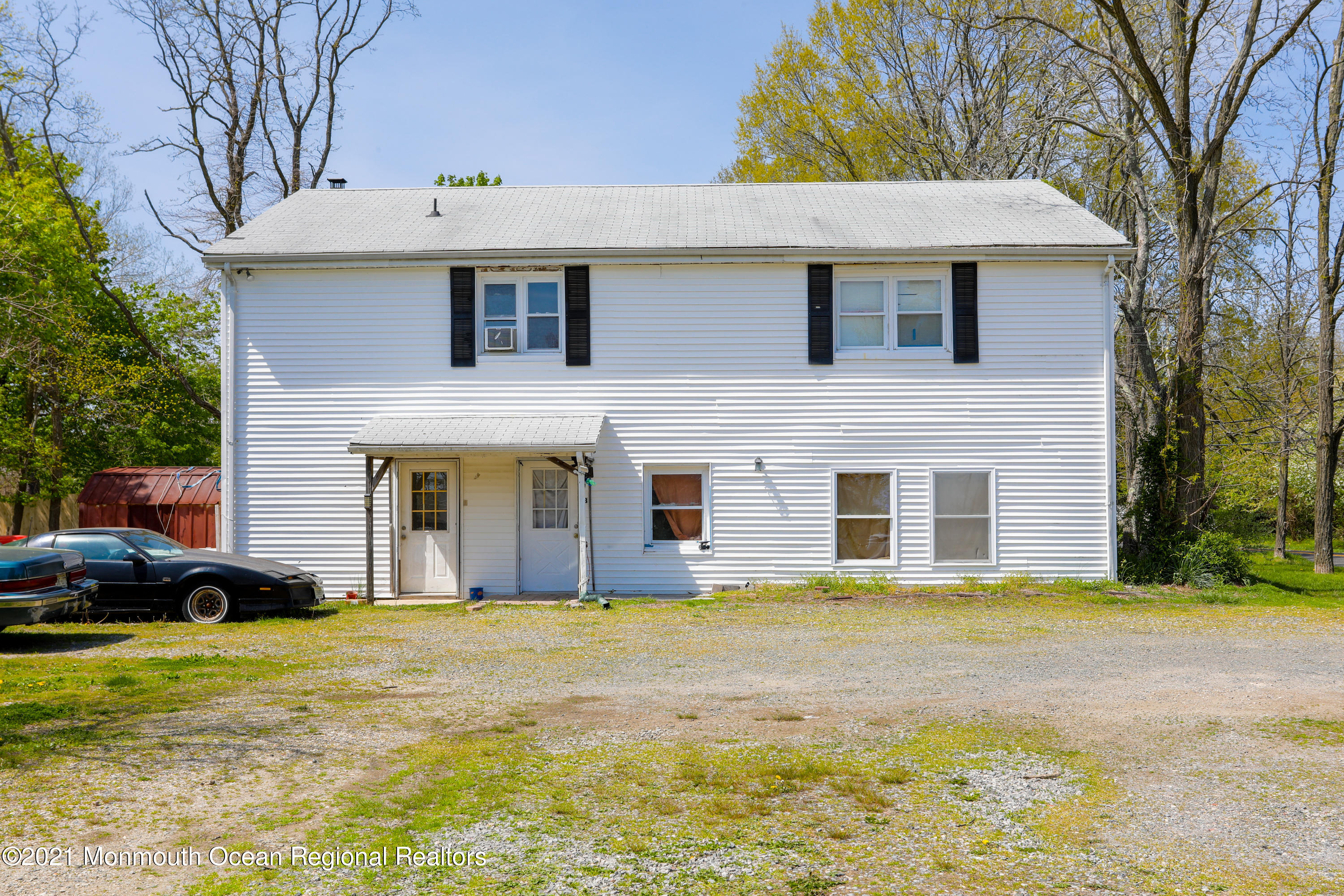 511 Squankum Yellowbrook Road Farmingdale, NJ 07727 - Photo 3 of 27 a front view of a house with a garden
